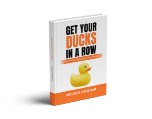 3D book cover of 'Get Your Ducks in a Row' by Michon Henegar, featuring a rubber duck; a guide to strategic focus and order.