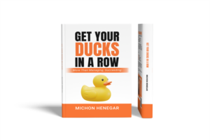 Book cover: 'Get Your Ducks In A Row' by Michon Henegar, featuring a rubber duck; a guide to organization and focus.
